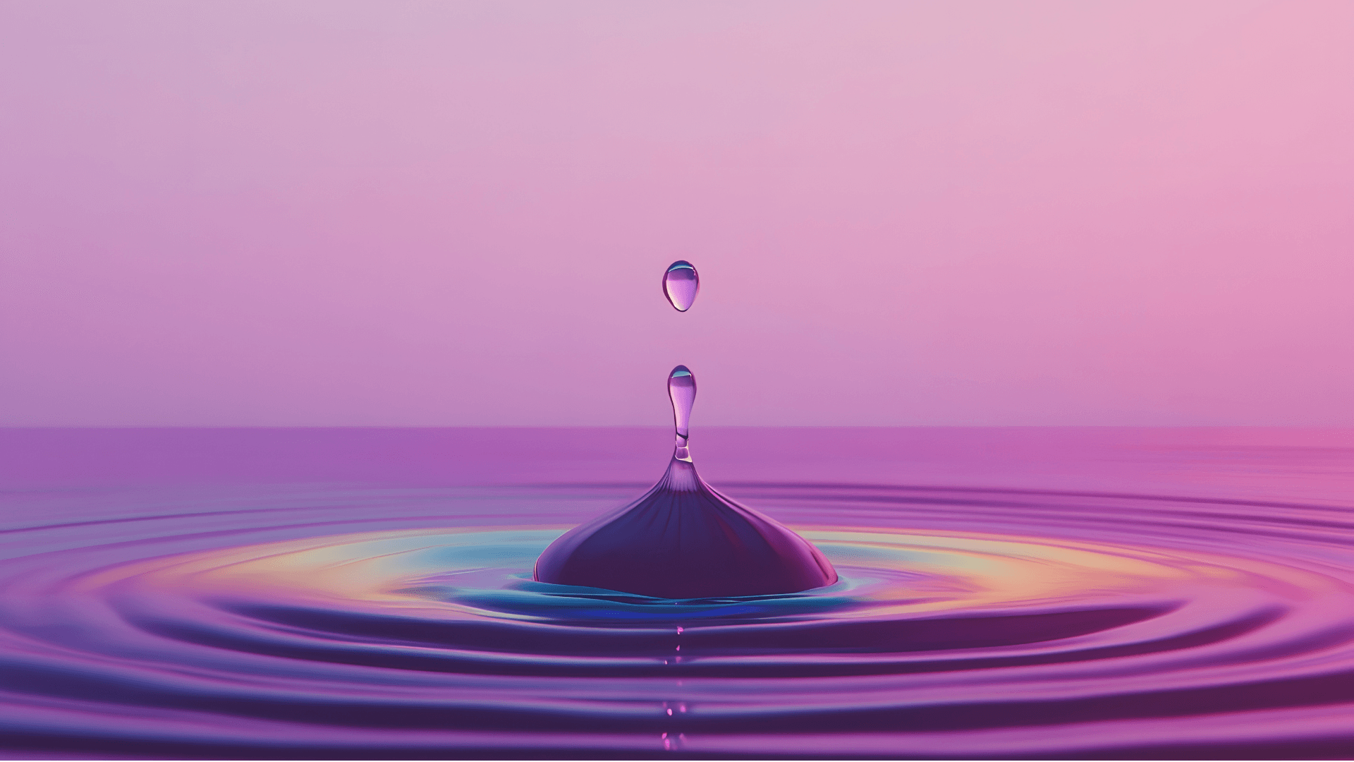 A single water droplet falling into still, purple-tinted water
